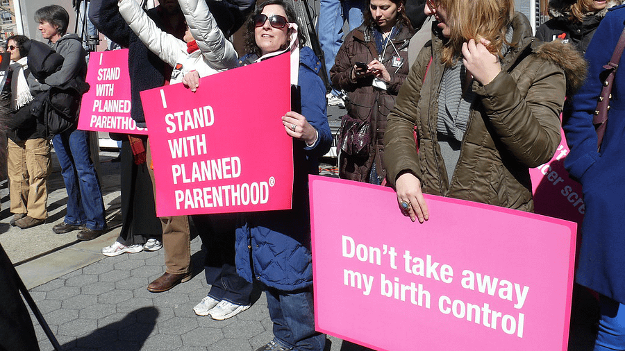 Supporters rally in favor of Planned Parenthood after Title X funding decision.